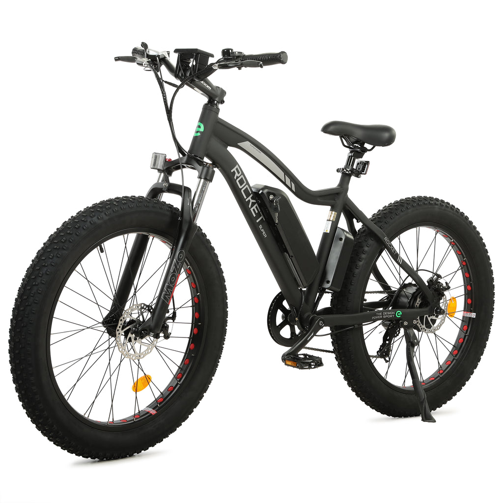 Ecotric Rocket electric bike with fat tires on a sandy beach, showcasing its robust frame and powerful motor for all-terrain cycling adventures.