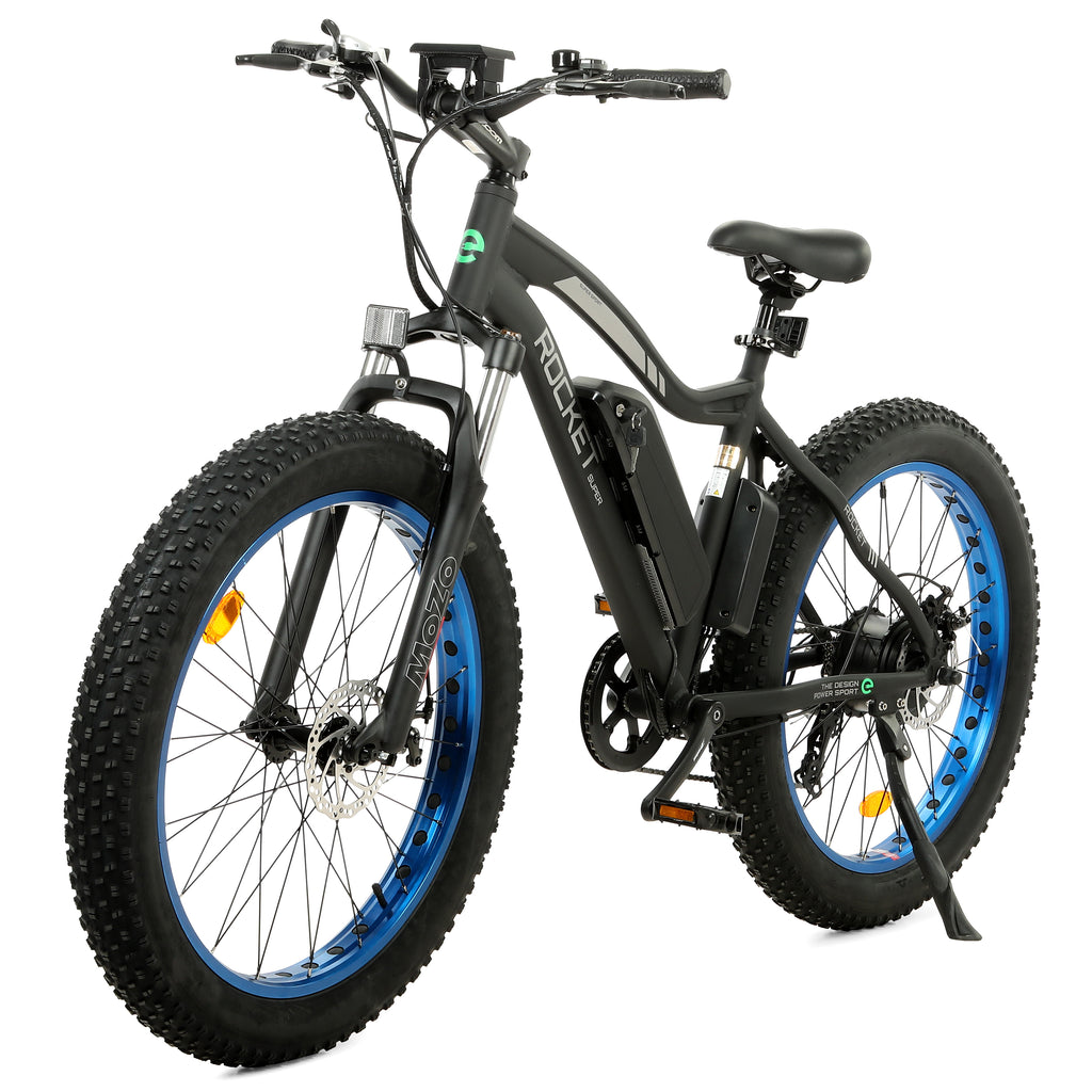 Ecotric Rocket electric bike with fat tires on a sandy beach, showcasing its robust frame and powerful motor for all-terrain cycling adventures.